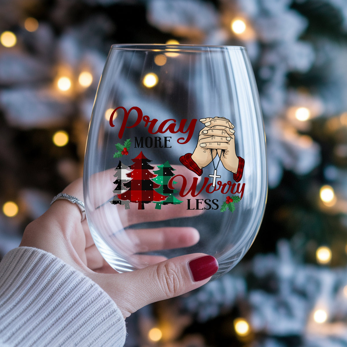 Pray More Worry Less Praying Hands UV DTF sticker applied to a stemless wine glass held in hand