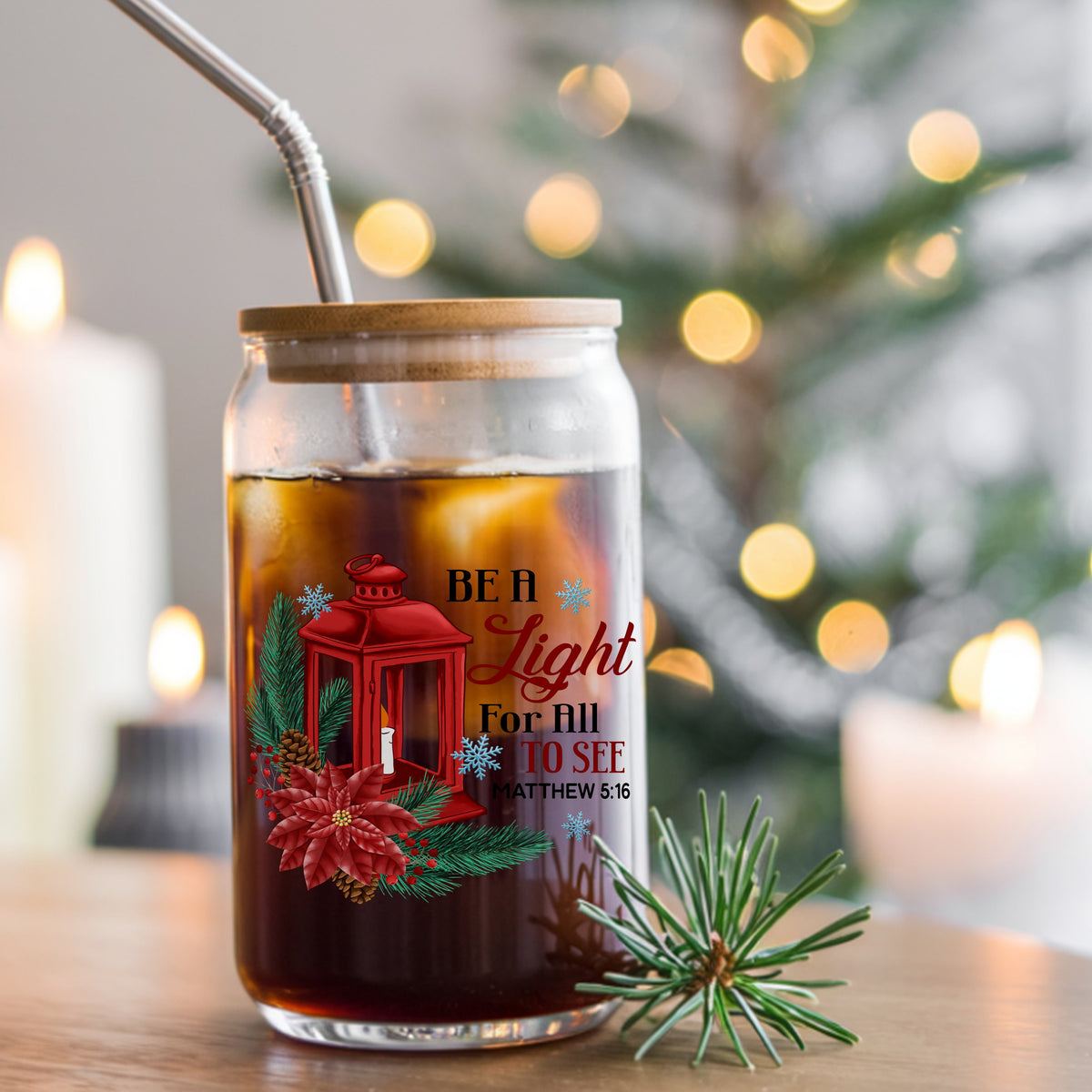 Be A Light Christmas Lantern UV DTF sticker applied to a glass can cup of iced coffee with a straw