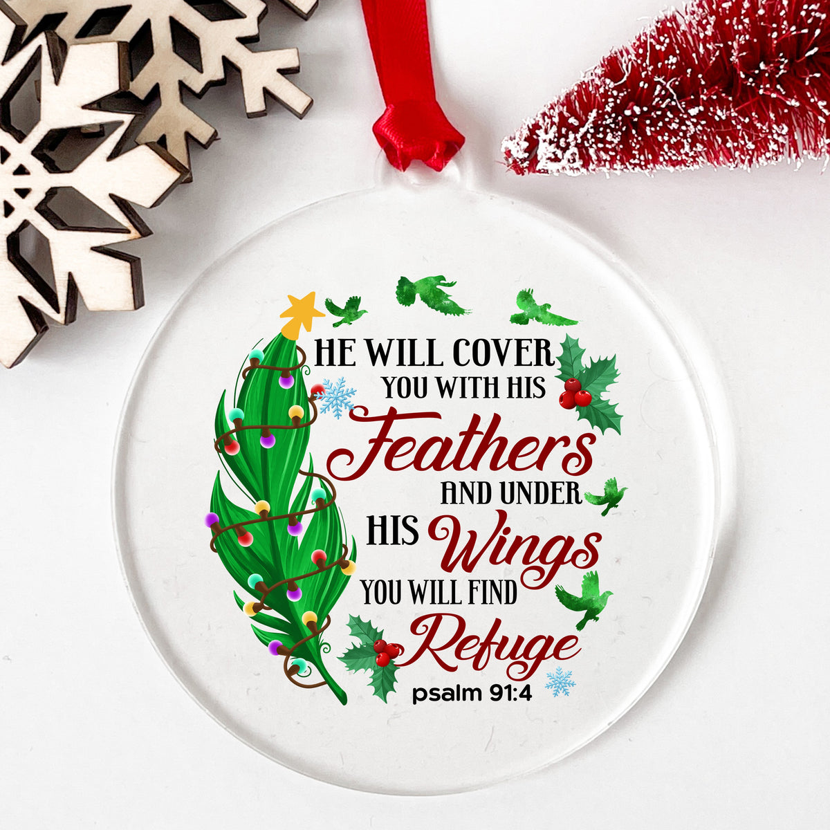 Psalm 91 Christmas Feather UV DTF sticker applied to a clear round acrylic ornament with a red ribbon