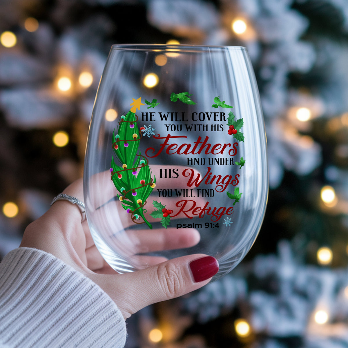 Psalm 91 Christmas Feather UV DTF sticker applied to a stemless wine glass held in hand