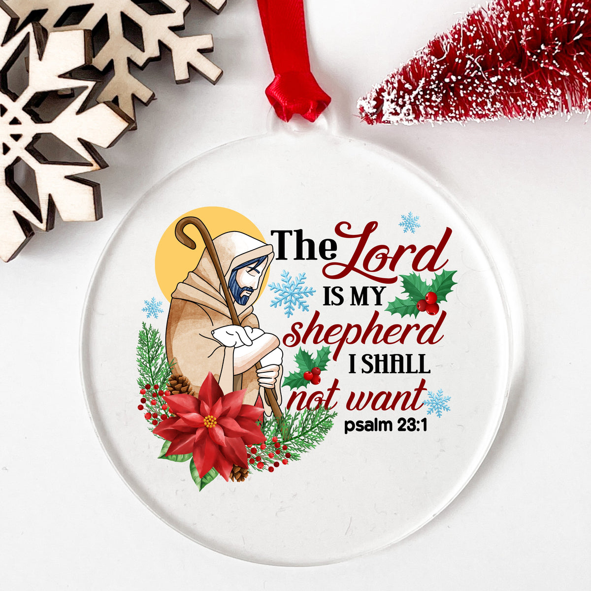 The Lord Is My Shepherd Jesus UV DTF sticker applied to a clear round acrylic ornament with a red ribbon
