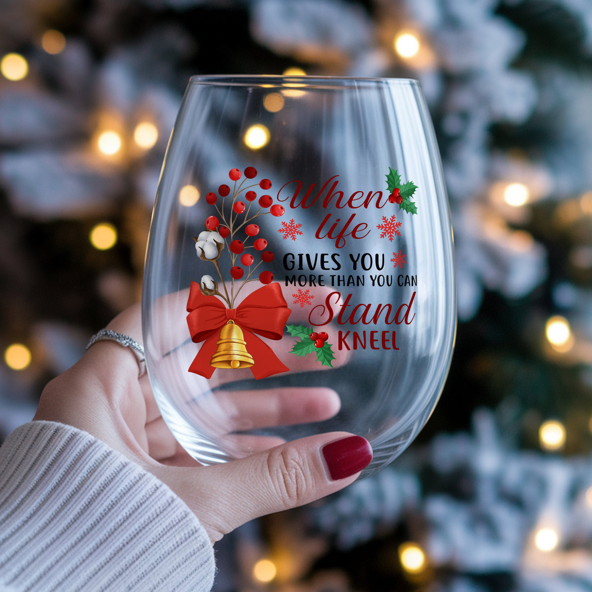 Kneel Faith Quote Red Bow UV DTF sticker applied to a stemless wine glass held in hand