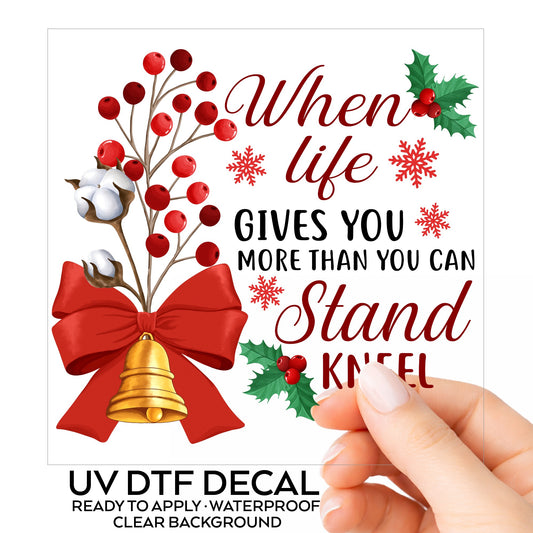 Kneel Faith Quote Red Bow UV DTF sticker on its backing card, held in hand