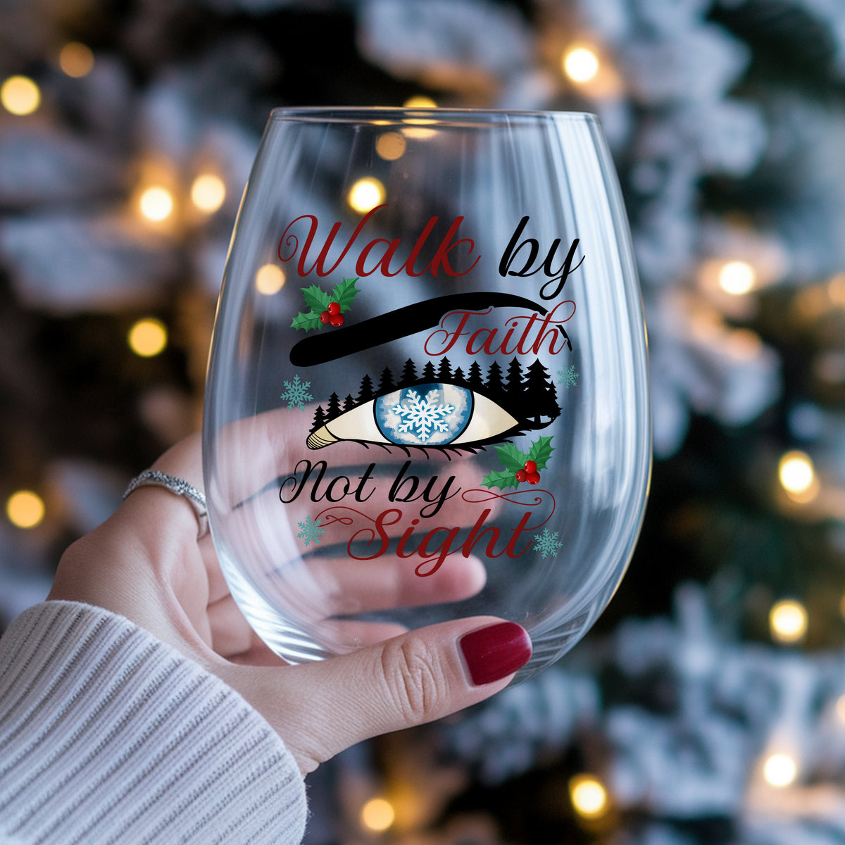 Walk By Faith Snowflake Eye UV DTF sticker applied to a stemless wine glass held in hand