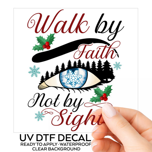 Walk By Faith Snowflake Eye UV DTF sticker on its backing card, held in hand
