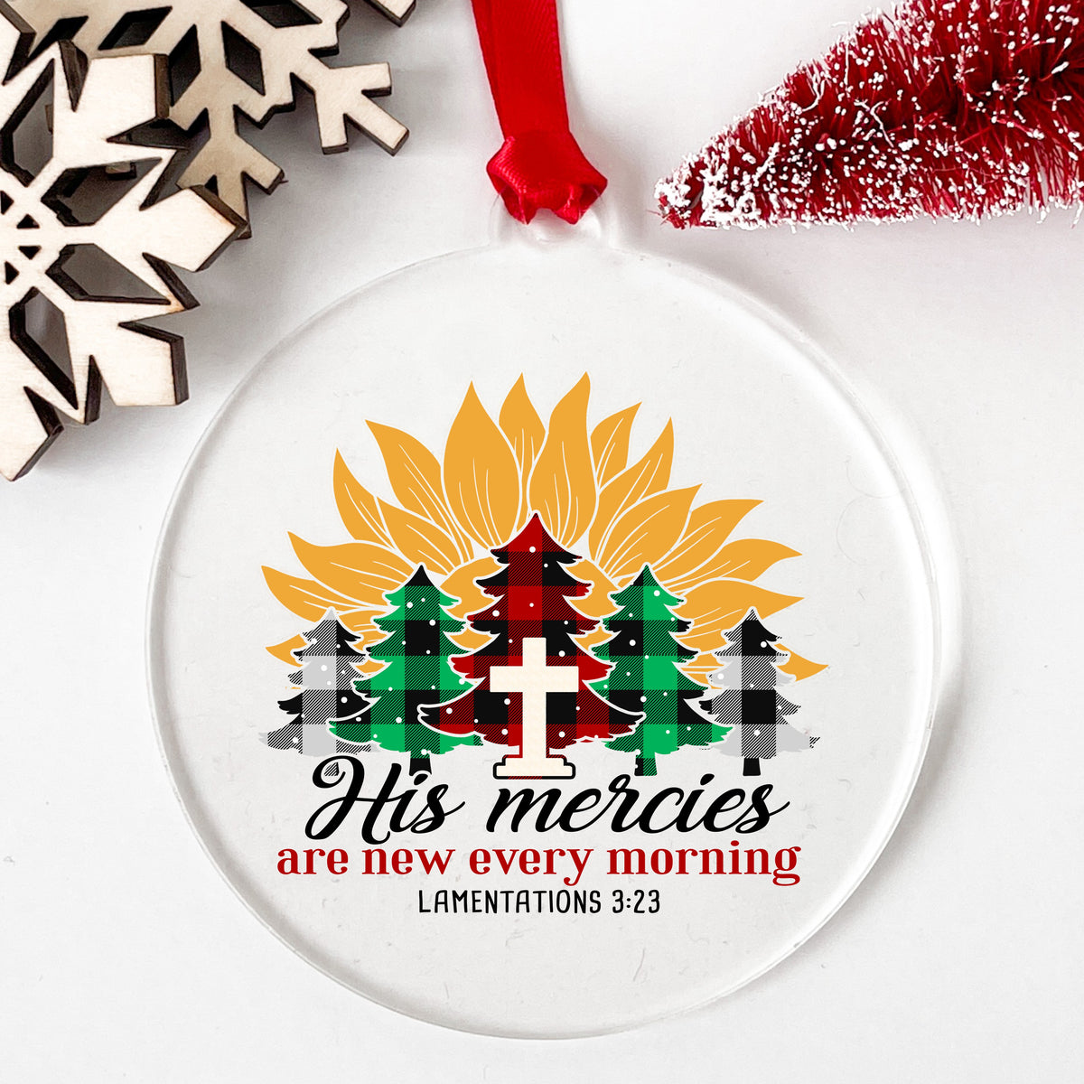 His Mercies Sunflower Christmas Tree UV DTF sticker applied to a clear round acrylic ornament with a red ribbon