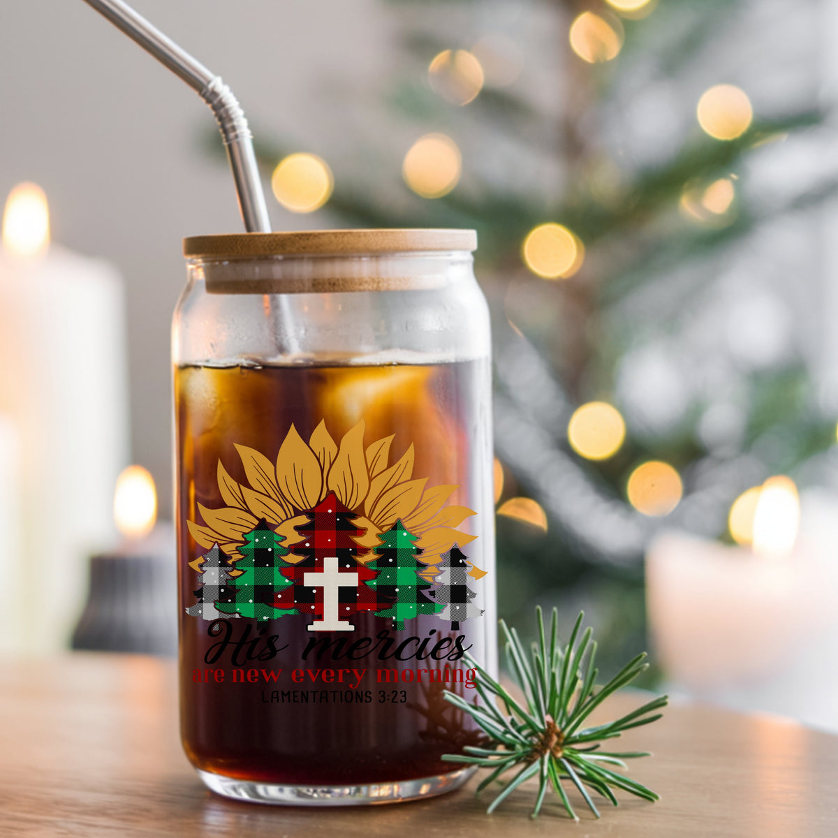 His Mercies Sunflower Christmas Tree UV DTF sticker applied to a glass can cup of iced coffee with a straw