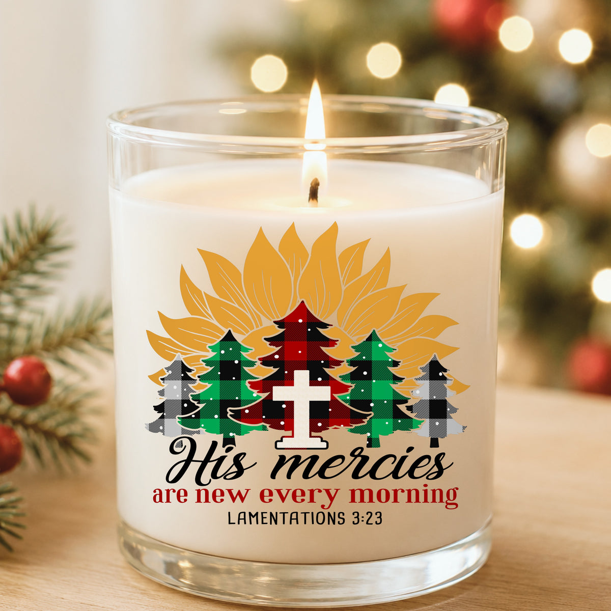 His Mercies Sunflower Christmas Tree UV DTF sticker applied to a white candle in a glass holder near Christmas lights