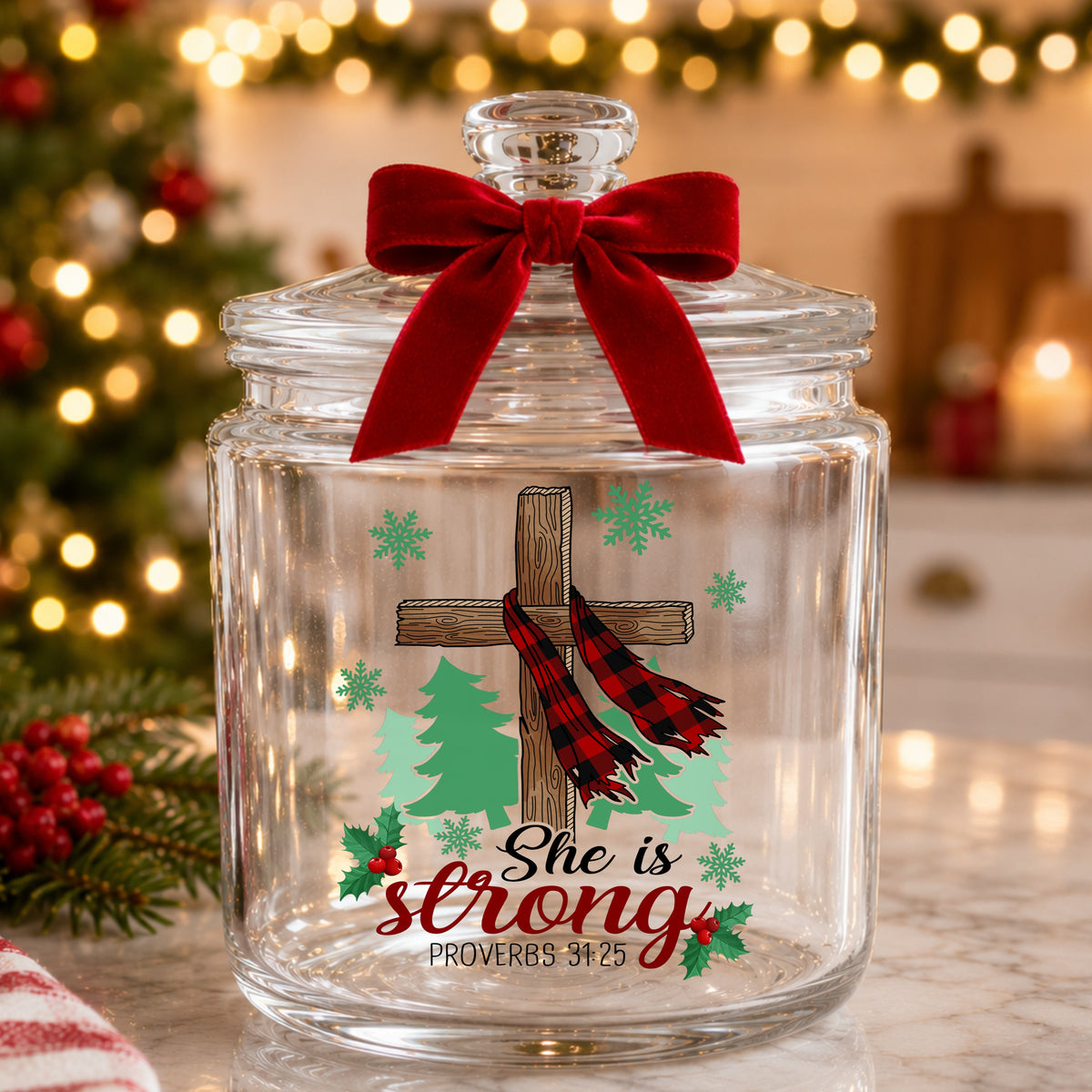She Is Strong Christmas Cross UV DTF sticker applied to a glass candy jar tied with a red bow
