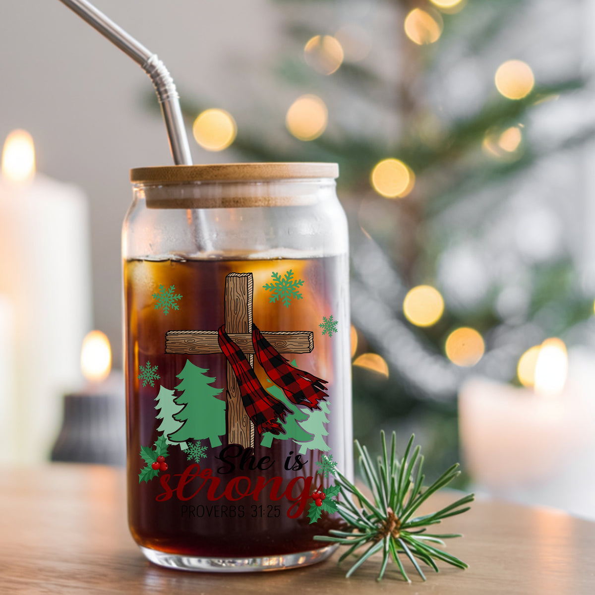 She Is Strong Christmas Cross UV DTF sticker applied to a glass can cup of iced coffee with a straw