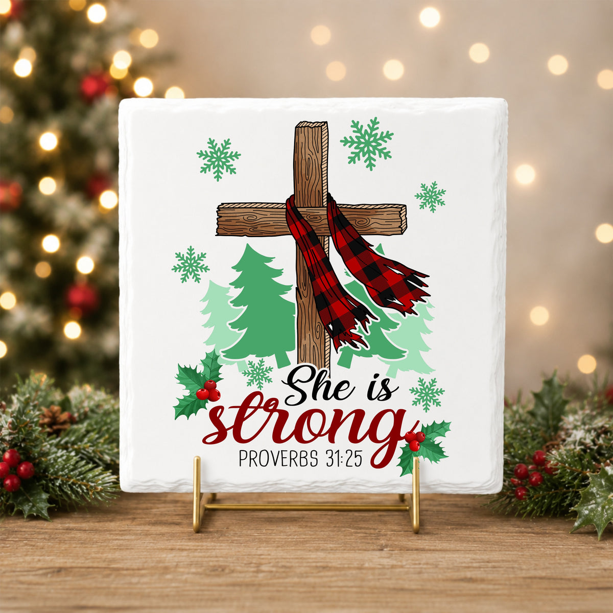 She Is Strong Christmas Cross UV DTF sticker applied to a white tile on a gold stand
