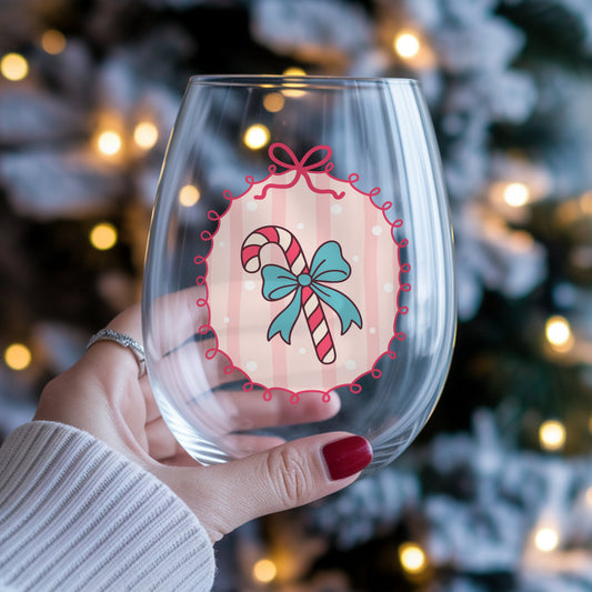 Coquette Candy Cane UV DTF sticker applied to a stemless wine glass held in hand