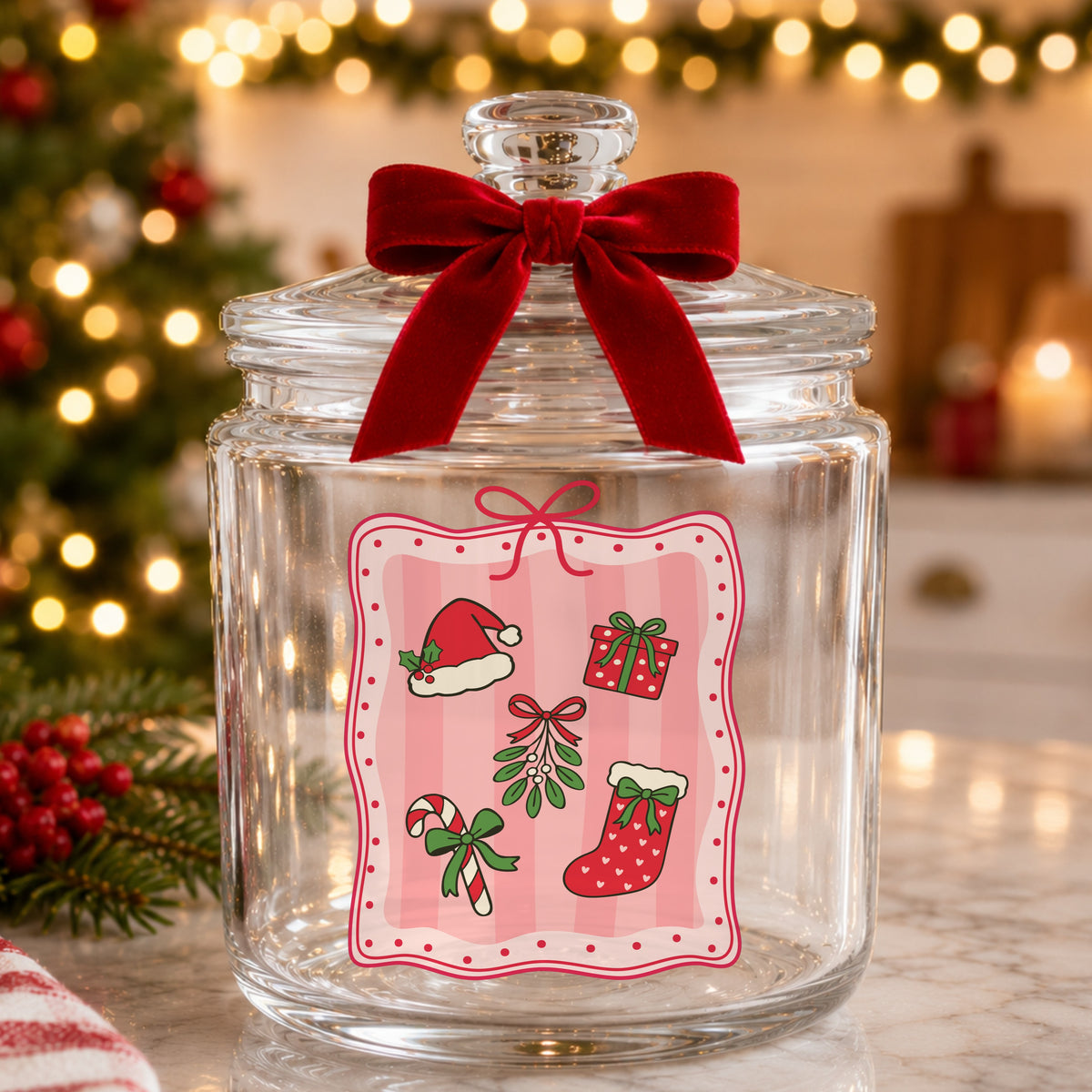 Coquette Christmas Icons Pink Frame UV DTF sticker applied to a glass candy jar tied with a red bow