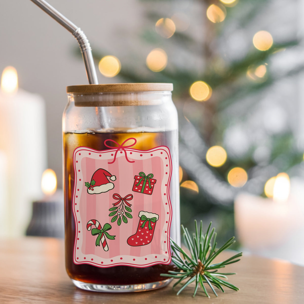 Coquette Christmas Icons Pink Frame UV DTF sticker applied to a glass can cup of iced coffee with a straw