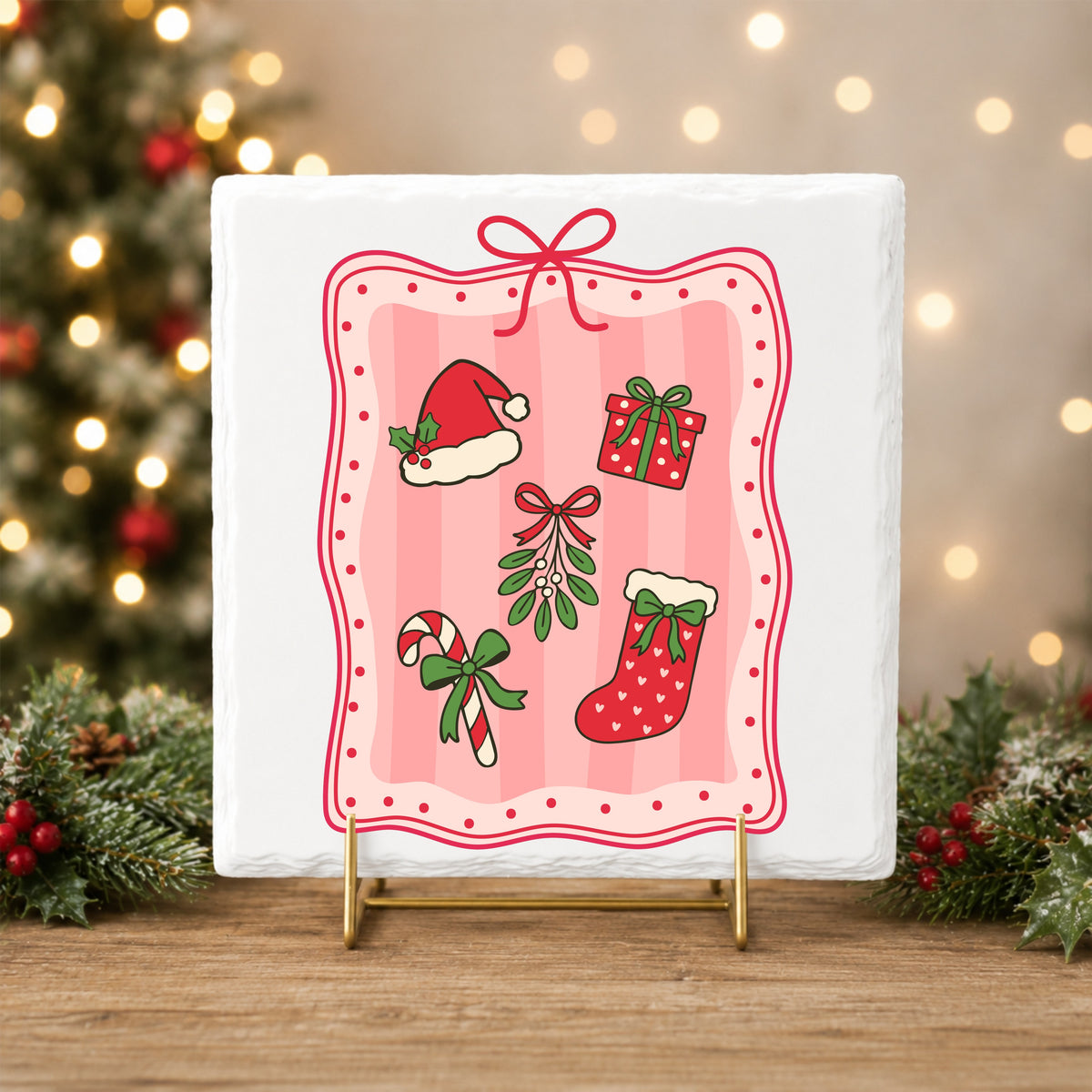 Coquette Christmas Icons Pink Frame UV DTF sticker applied to a white tile on a gold stand
