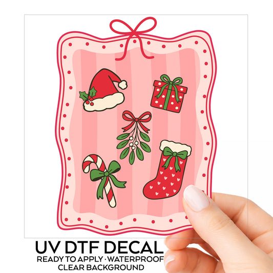 Coquette Christmas Icons Pink Frame UV DTF sticker on its backing card, held in hand
