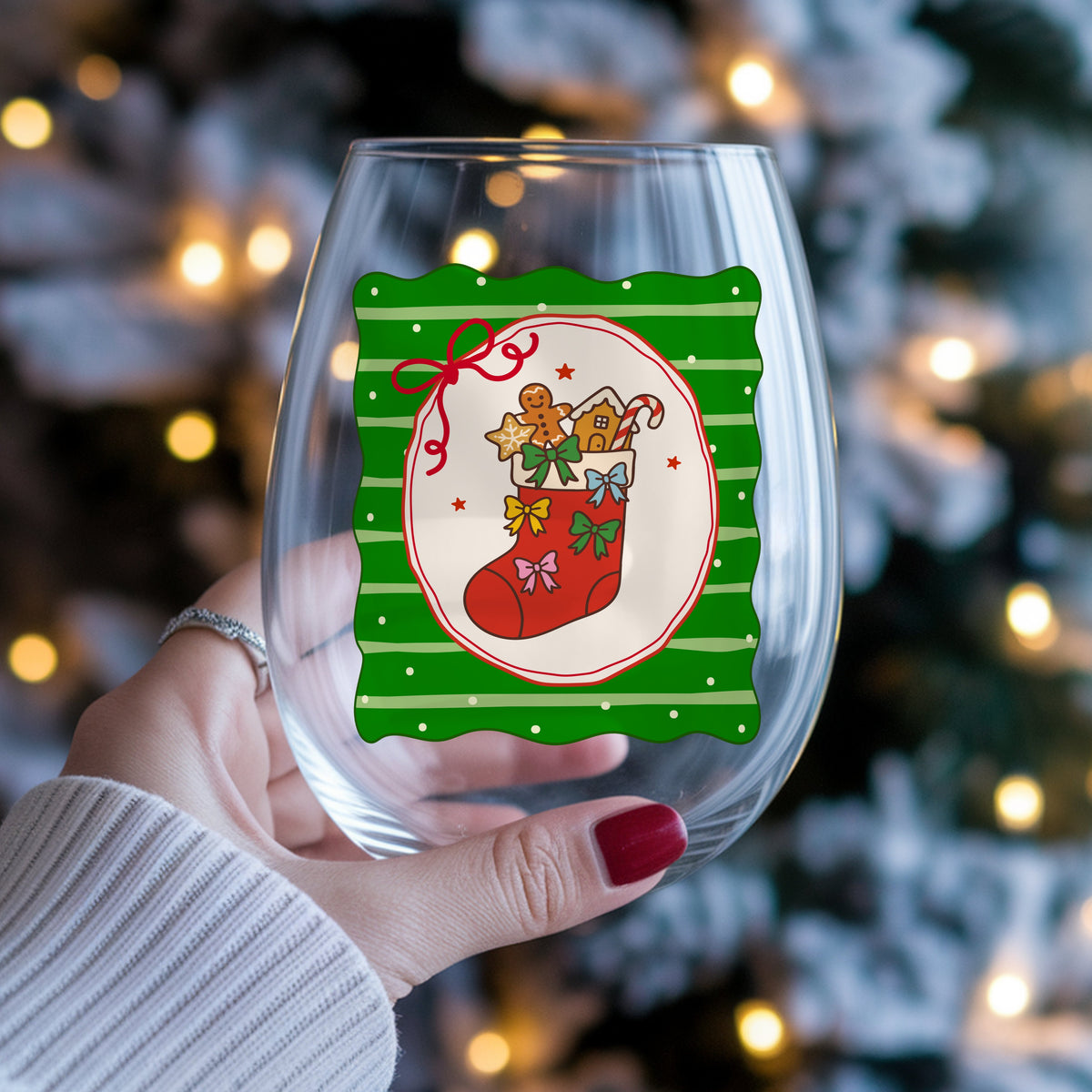 Coquette Gingerbread Stocking UV DTF sticker applied to a stemless wine glass held in hand