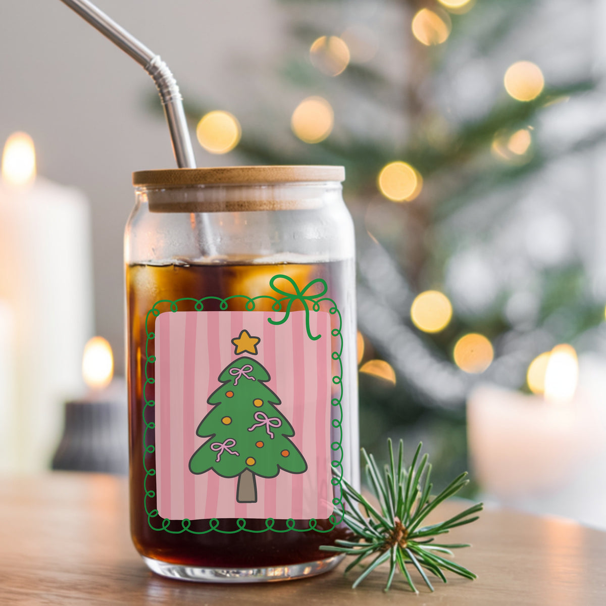 Coquette Pink Bow Christmas Tree UV DTF sticker applied to a glass can cup of iced coffee with a straw