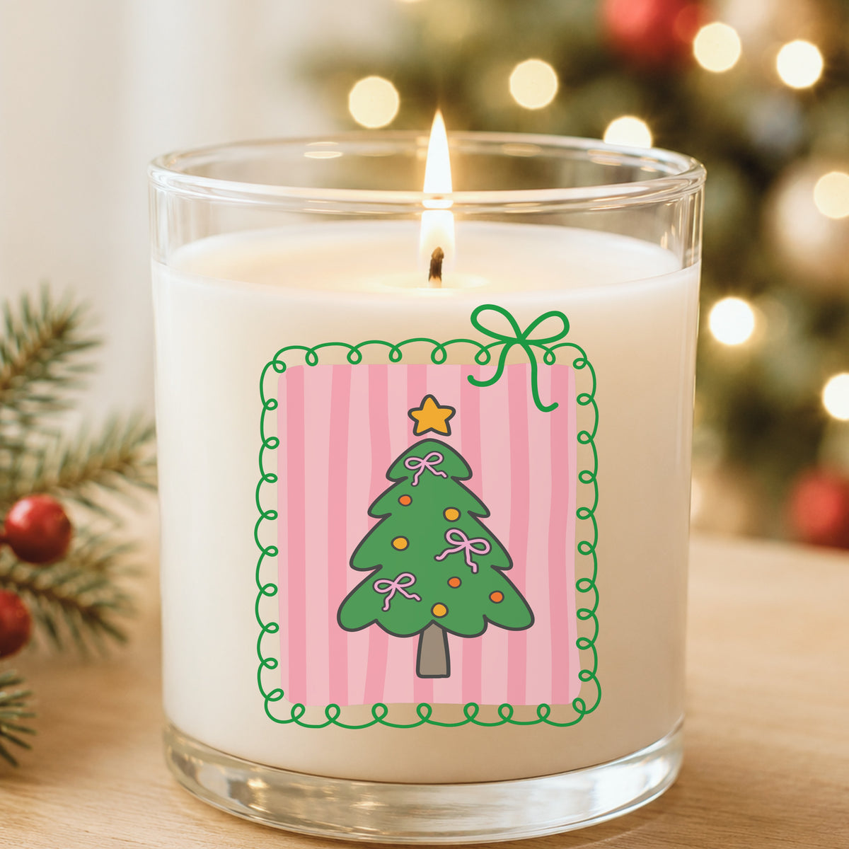 Coquette Pink Bow Christmas Tree UV DTF sticker applied to a white candle in a glass holder near Christmas lights