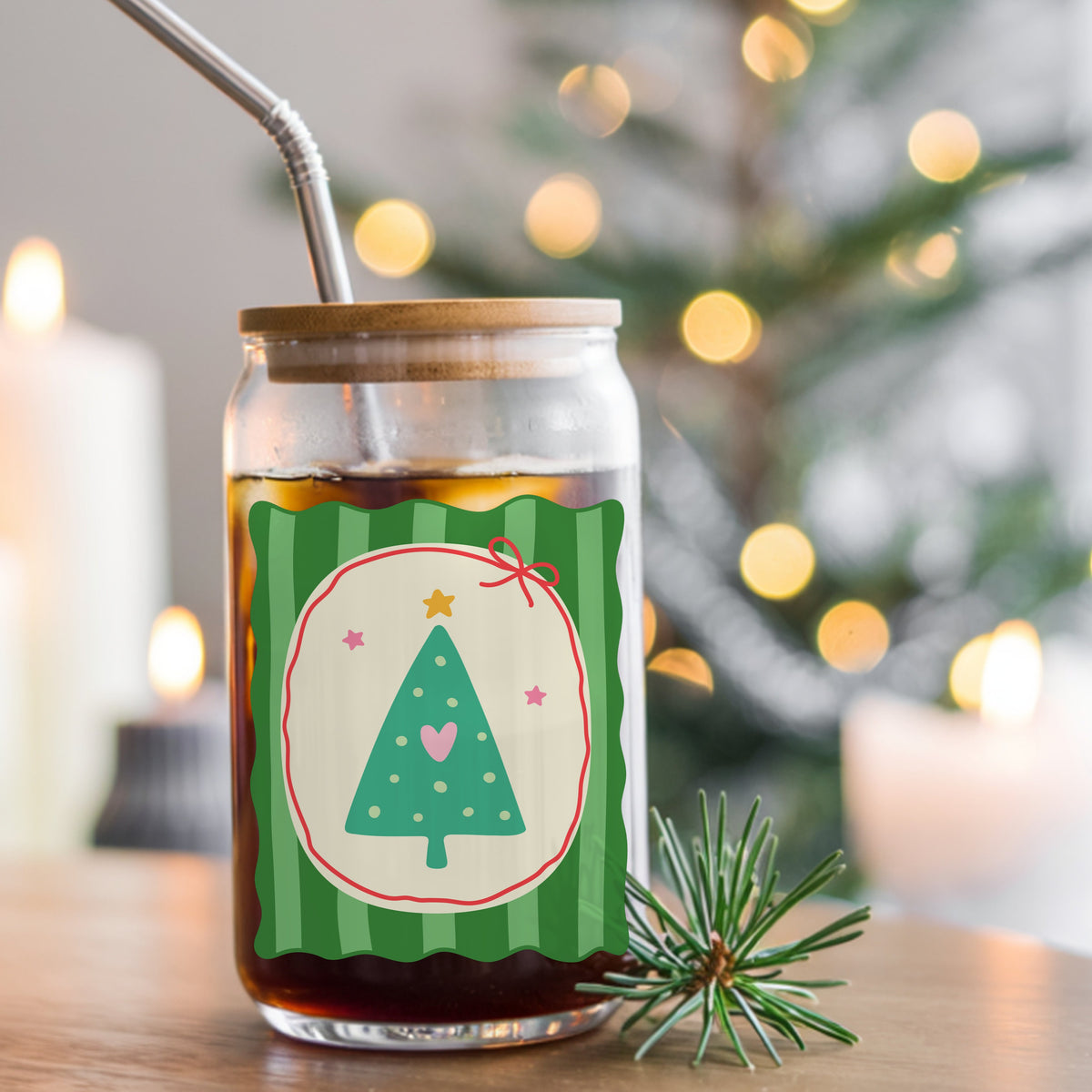 Coquette Teal Heart Christmas Tree UV DTF sticker applied to a glass can cup of iced coffee with a straw