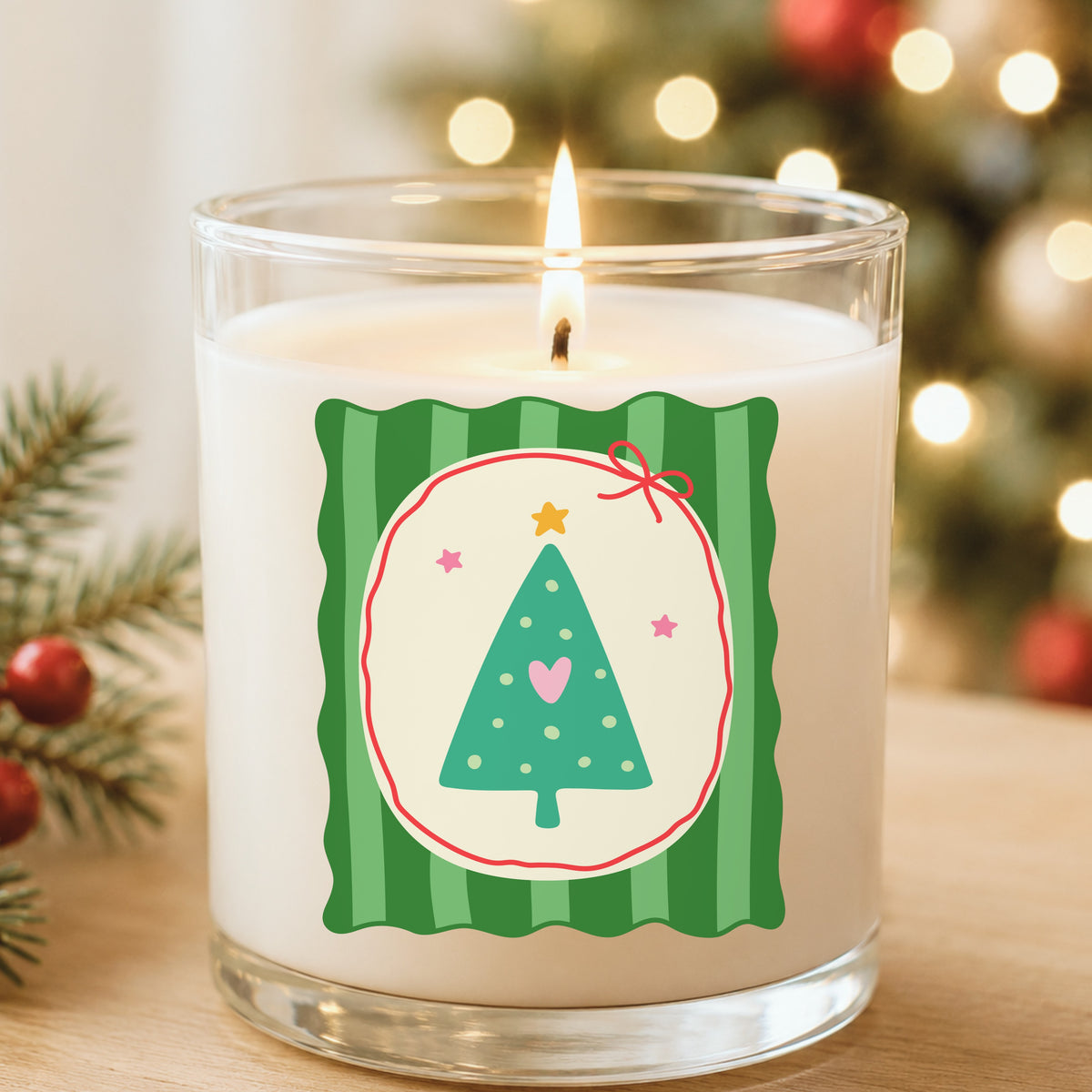 Coquette Teal Heart Christmas Tree UV DTF sticker applied to a white candle in a glass holder near Christmas lights