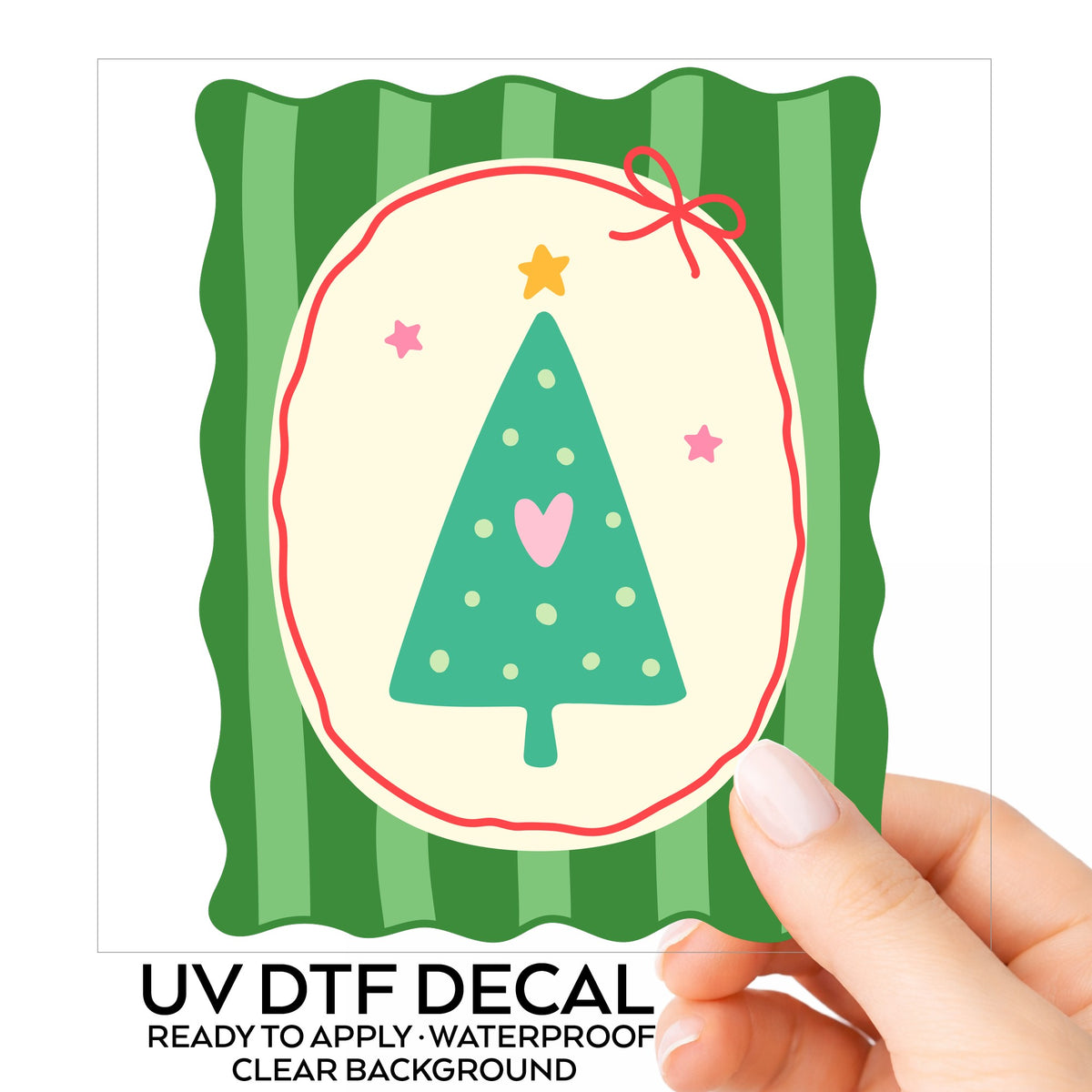 Coquette Teal Heart Christmas Tree UV DTF sticker on its backing card, held in hand