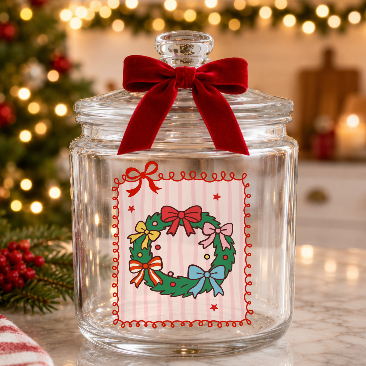 Coquette Bow Christmas Wreath UV DTF sticker applied to a glass candy jar tied with a red bow