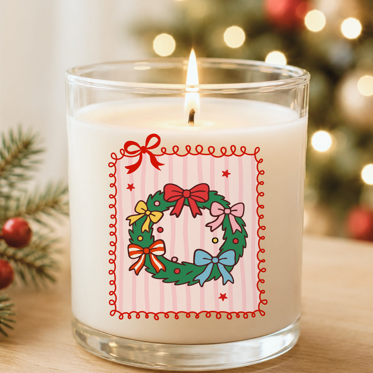 Coquette Bow Christmas Wreath UV DTF sticker applied to a white candle in a glass holder near Christmas lights