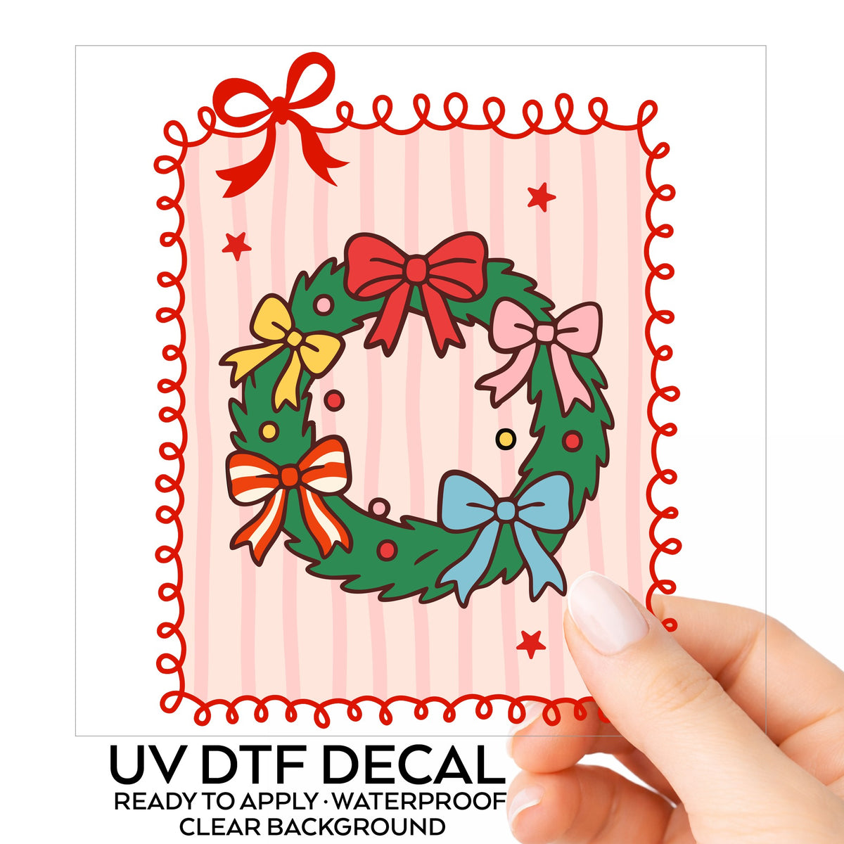 Coquette Bow Christmas Wreath UV DTF sticker on its backing card, held in hand