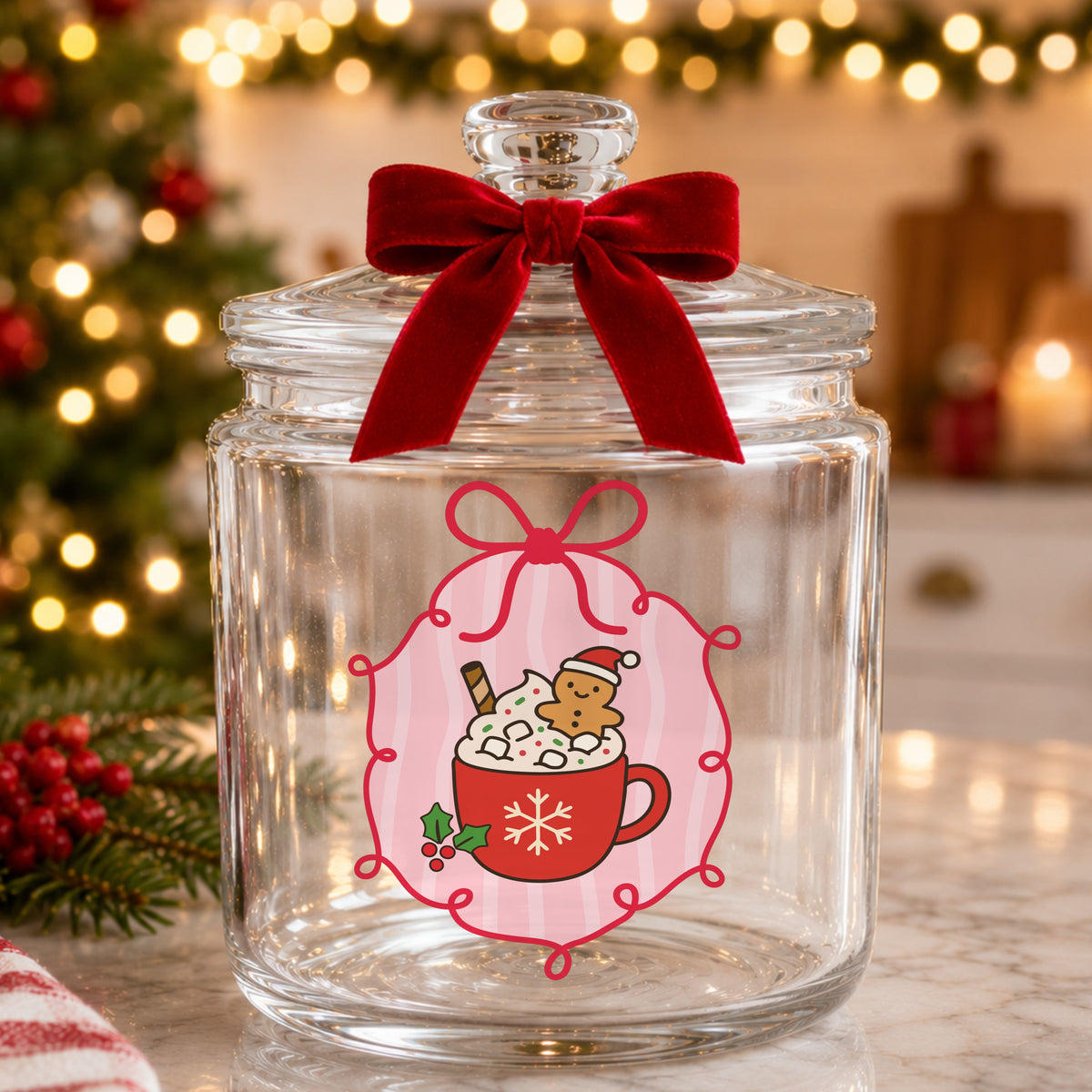 Coquette Gingerbread Hot Cocoa UV DTF sticker applied to a glass candy jar tied with a red bow