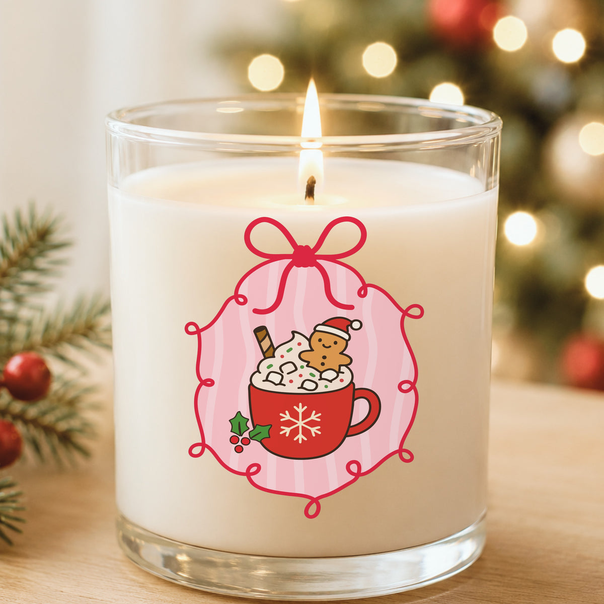 Coquette Gingerbread Hot Cocoa UV DTF sticker applied to a white candle in a glass holder near Christmas lights