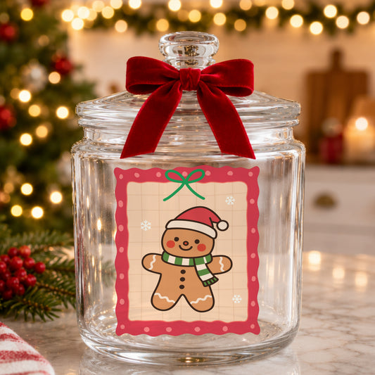 Coquette Gingerbread Man UV DTF sticker applied to a glass candy jar tied with a red bow