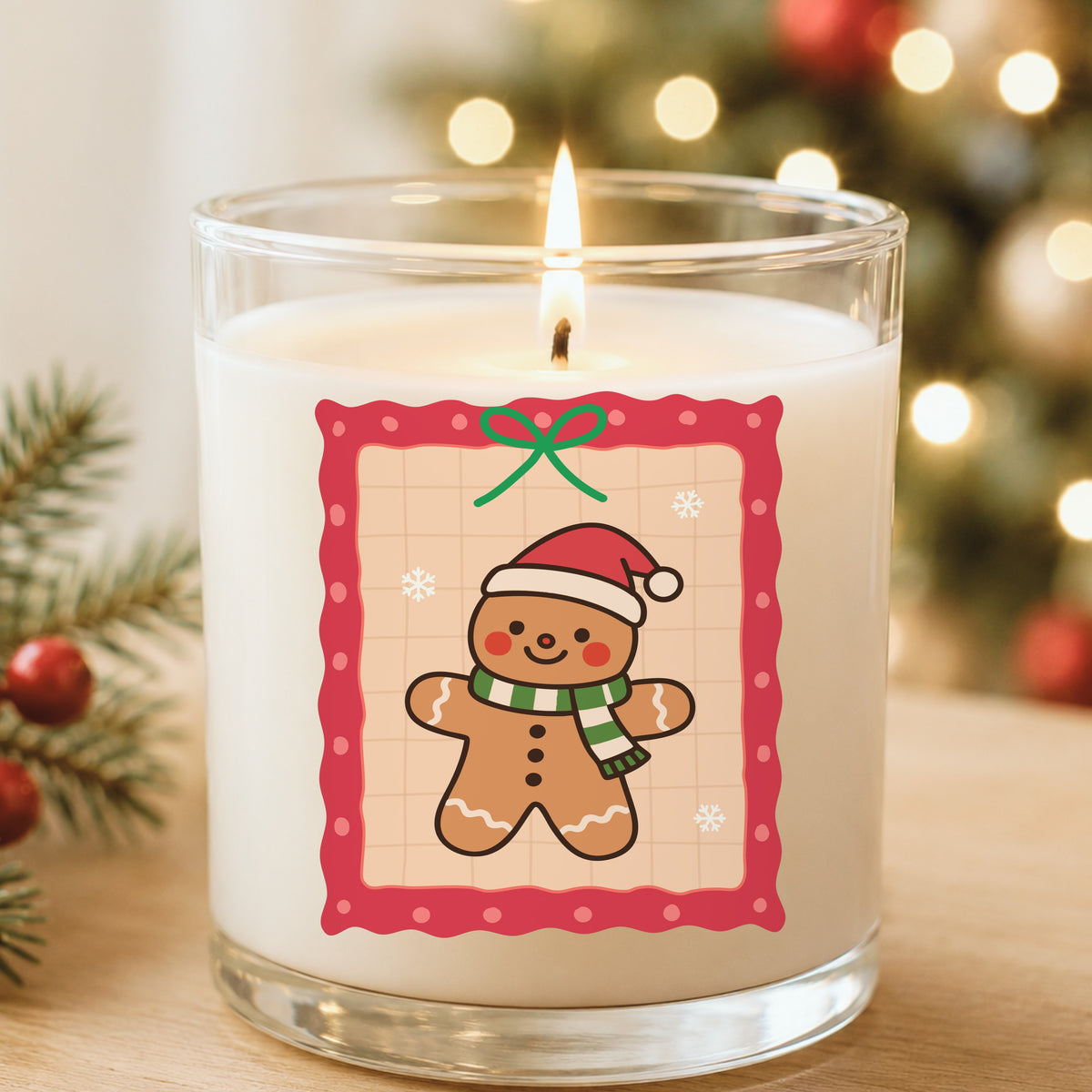 Coquette Gingerbread Man UV DTF sticker applied to a white candle in a glass holder near Christmas lights