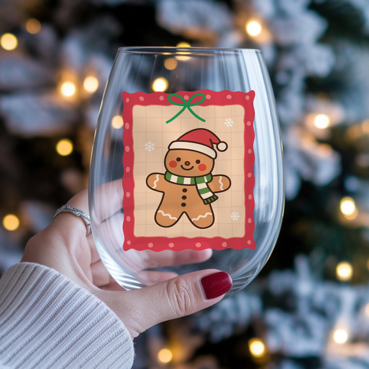 Coquette Gingerbread Man UV DTF sticker applied to a stemless wine glass held in hand