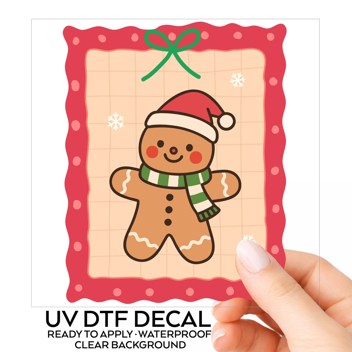 Coquette Gingerbread Man UV DTF sticker on its backing card, held in hand