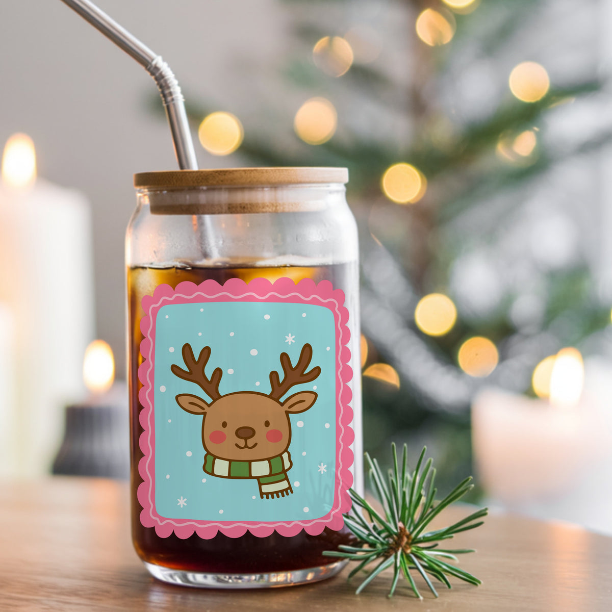 Coquette Reindeer Face UV DTF sticker applied to a glass can cup of iced coffee with a straw