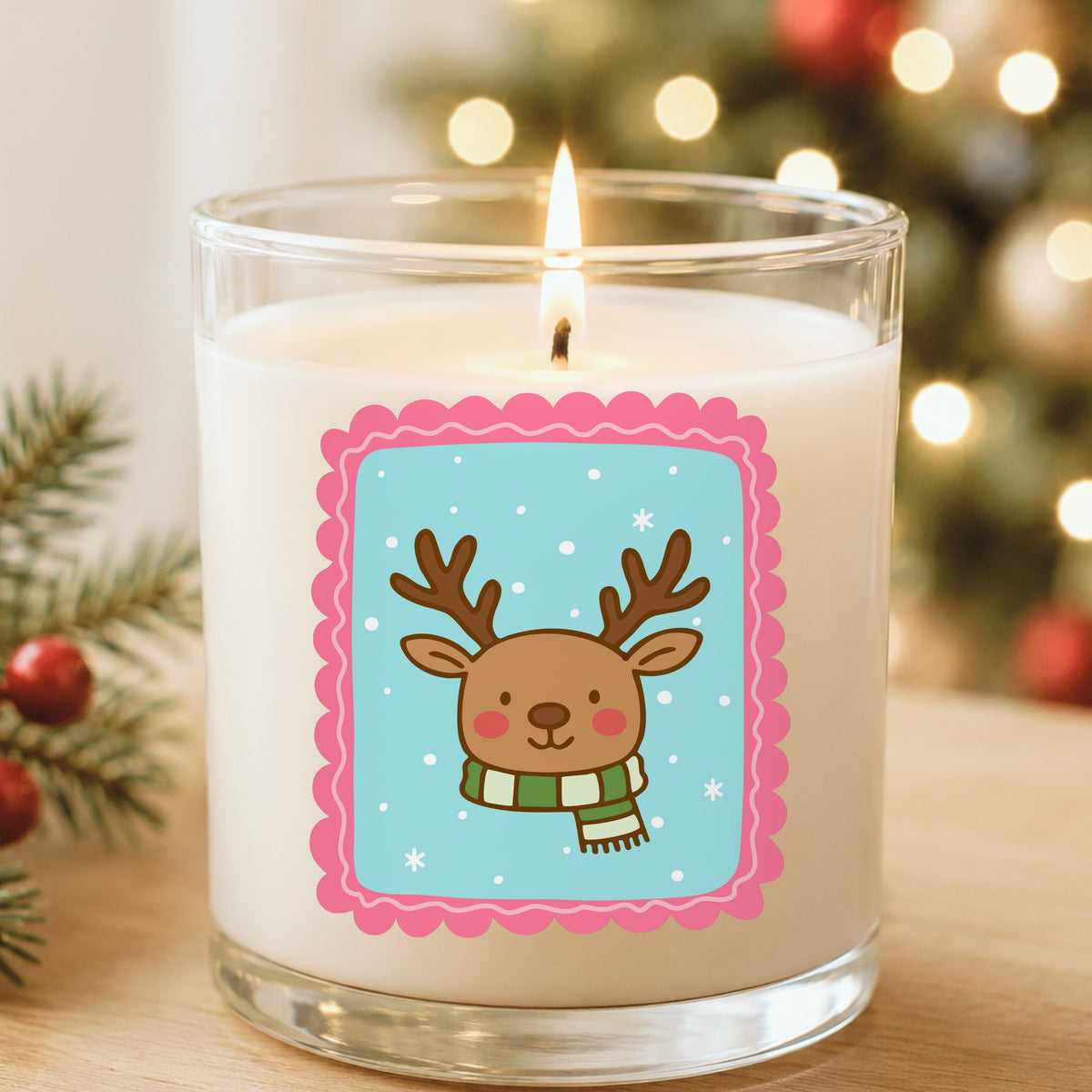 Coquette Reindeer Face UV DTF sticker applied to a white candle in a glass holder near Christmas lights