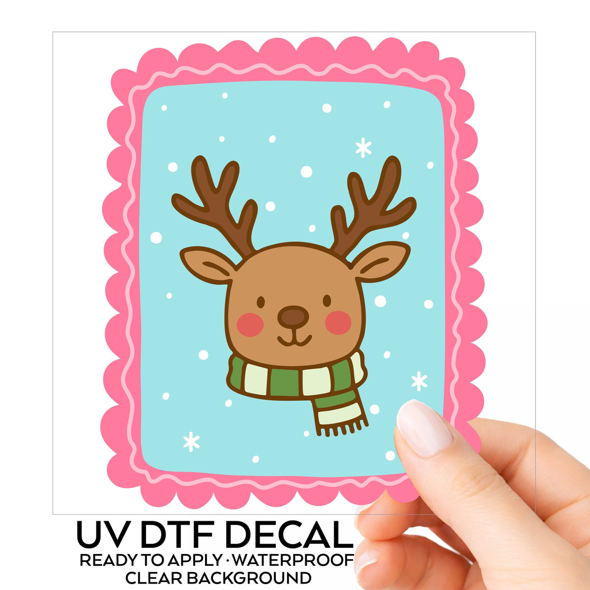 Coquette Reindeer Face UV DTF sticker on its backing card, held in hand
