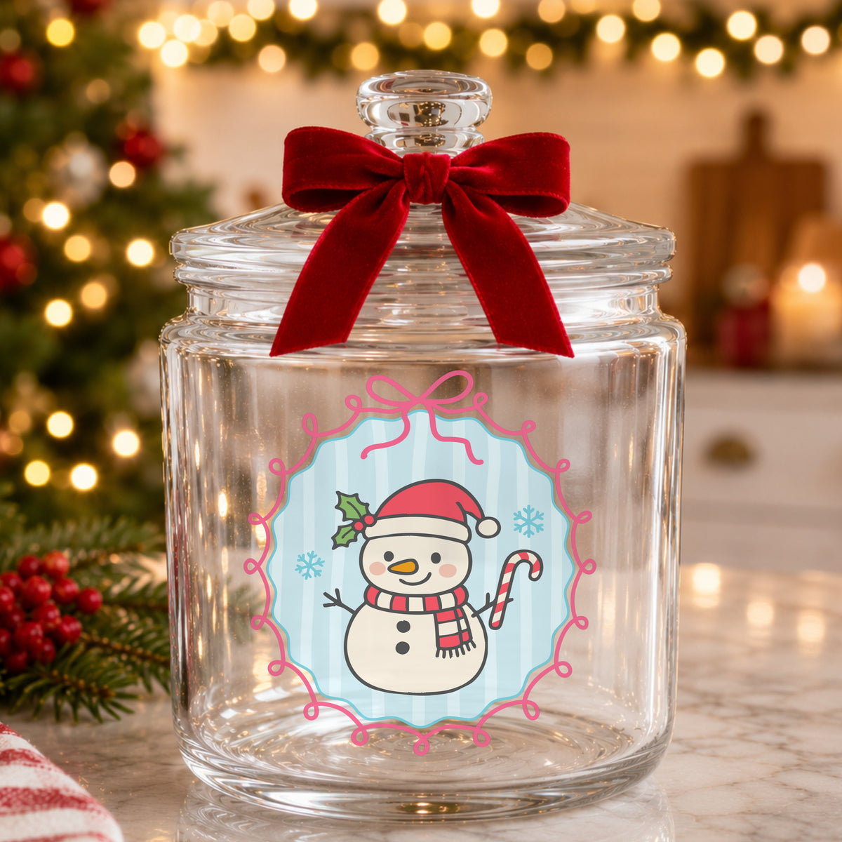 Coquette Snowman Candy Cane UV DTF sticker applied to a glass candy jar tied with a red bow