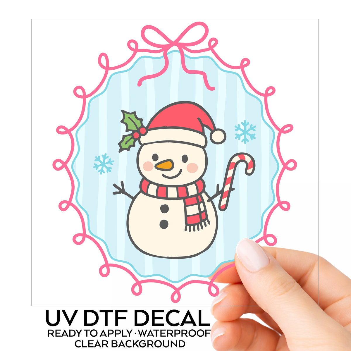 Coquette Snowman Candy Cane UV DTF sticker on its backing card, held in hand