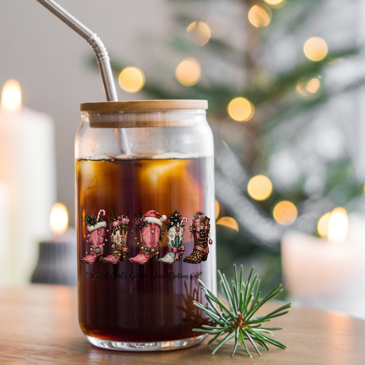 A Girls Gotta Have Options Christmas Boots UV DTF sticker applied to a glass can cup of iced coffee with a straw
