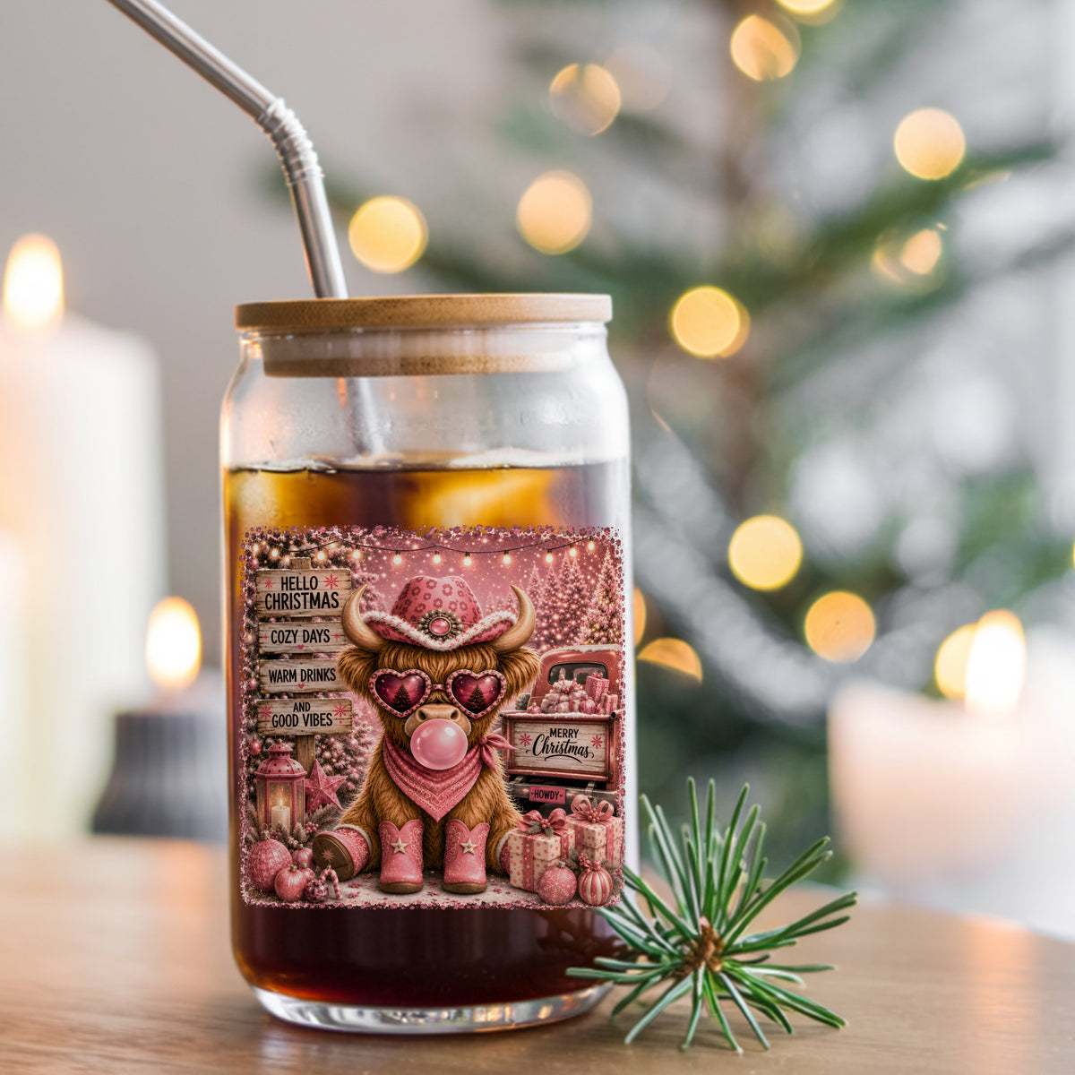 Pink Highland Cow Hello Christmas UV DTF sticker applied to a glass can cup of iced coffee with a straw