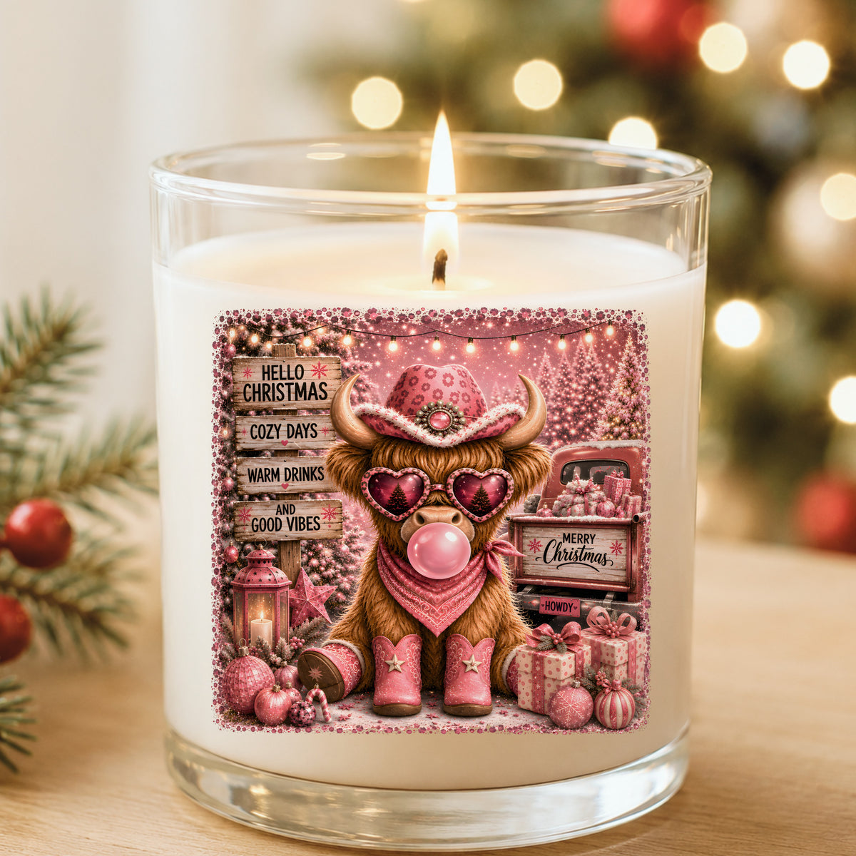 Pink Highland Cow Hello Christmas UV DTF sticker applied to a white candle in a glass holder near Christmas lights