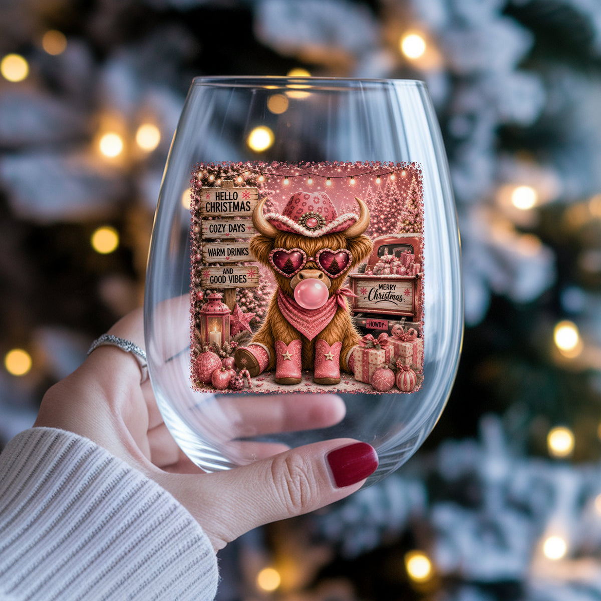 Pink Highland Cow Hello Christmas UV DTF sticker applied to a stemless wine glass held in hand