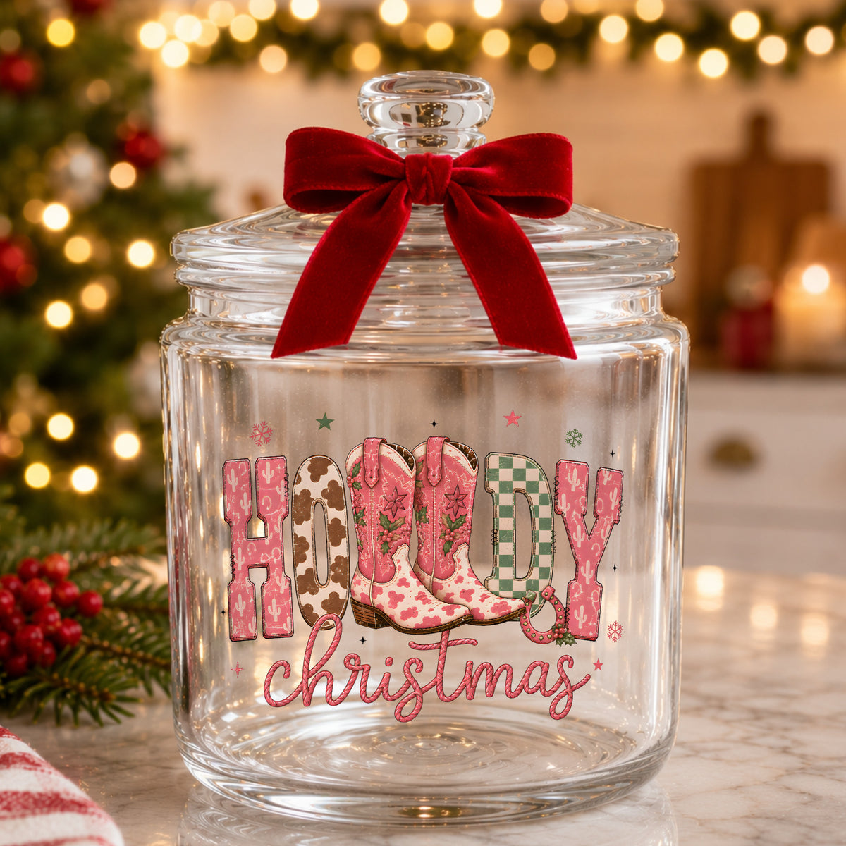 Howdy Christmas Cowboy Boots UV DTF sticker applied to a glass candy jar tied with a red bow