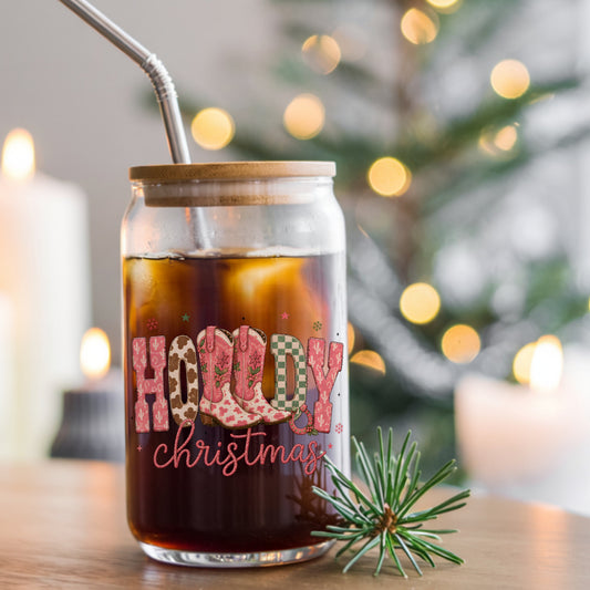 Howdy Christmas Cowboy Boots UV DTF sticker applied to a glass can cup of iced coffee with a straw