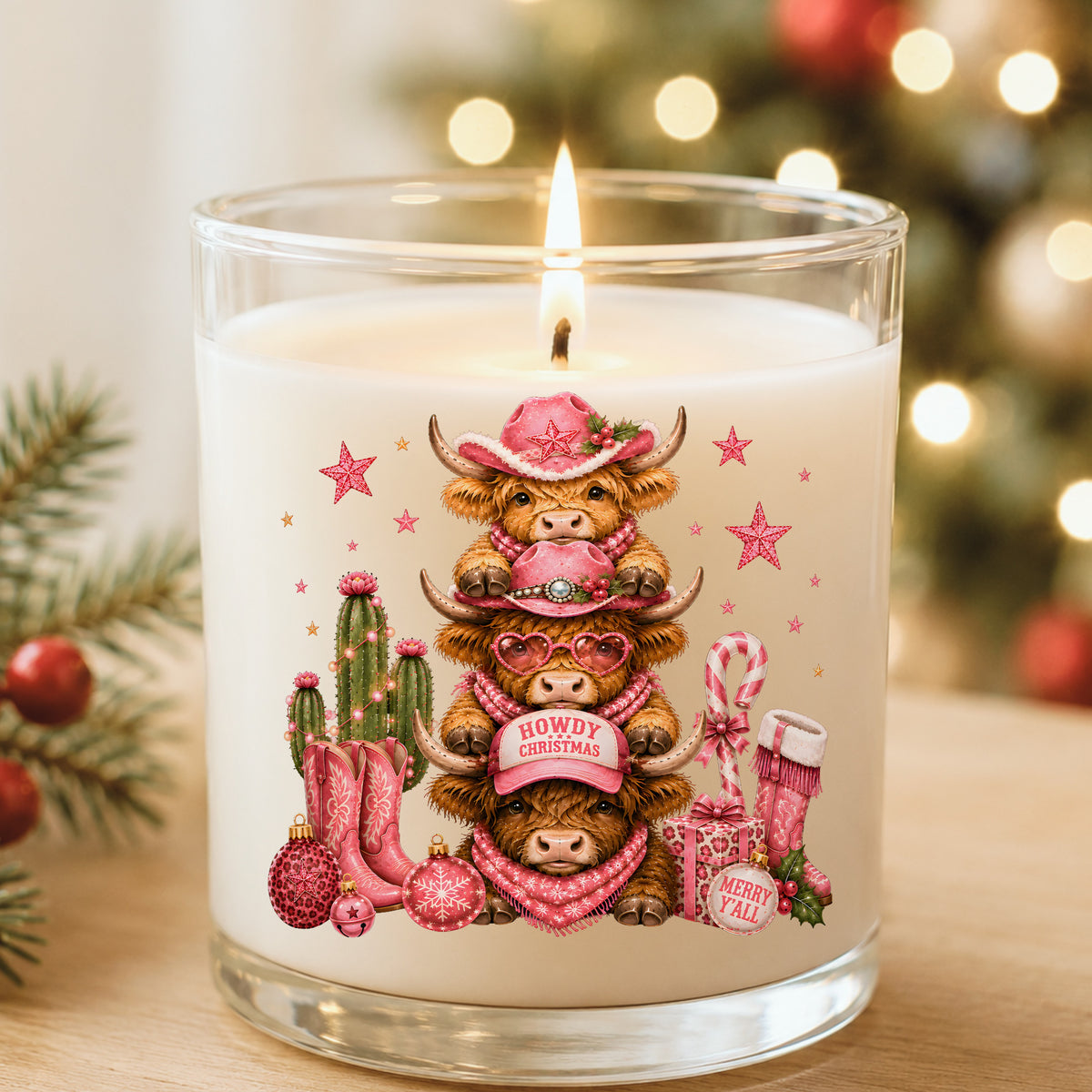 Stacked Highland Cows Howdy Christmas UV DTF sticker applied to a white candle in a glass holder near Christmas lights