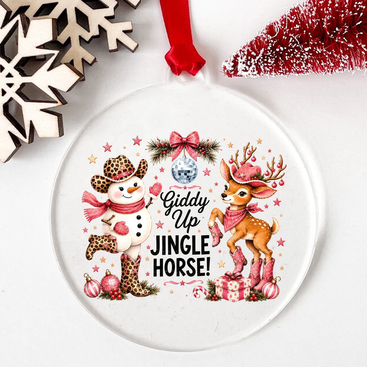 Giddy Up Jingle Horse Snowman Reindeer UV DTF sticker applied to a clear round acrylic ornament with a red ribbon
