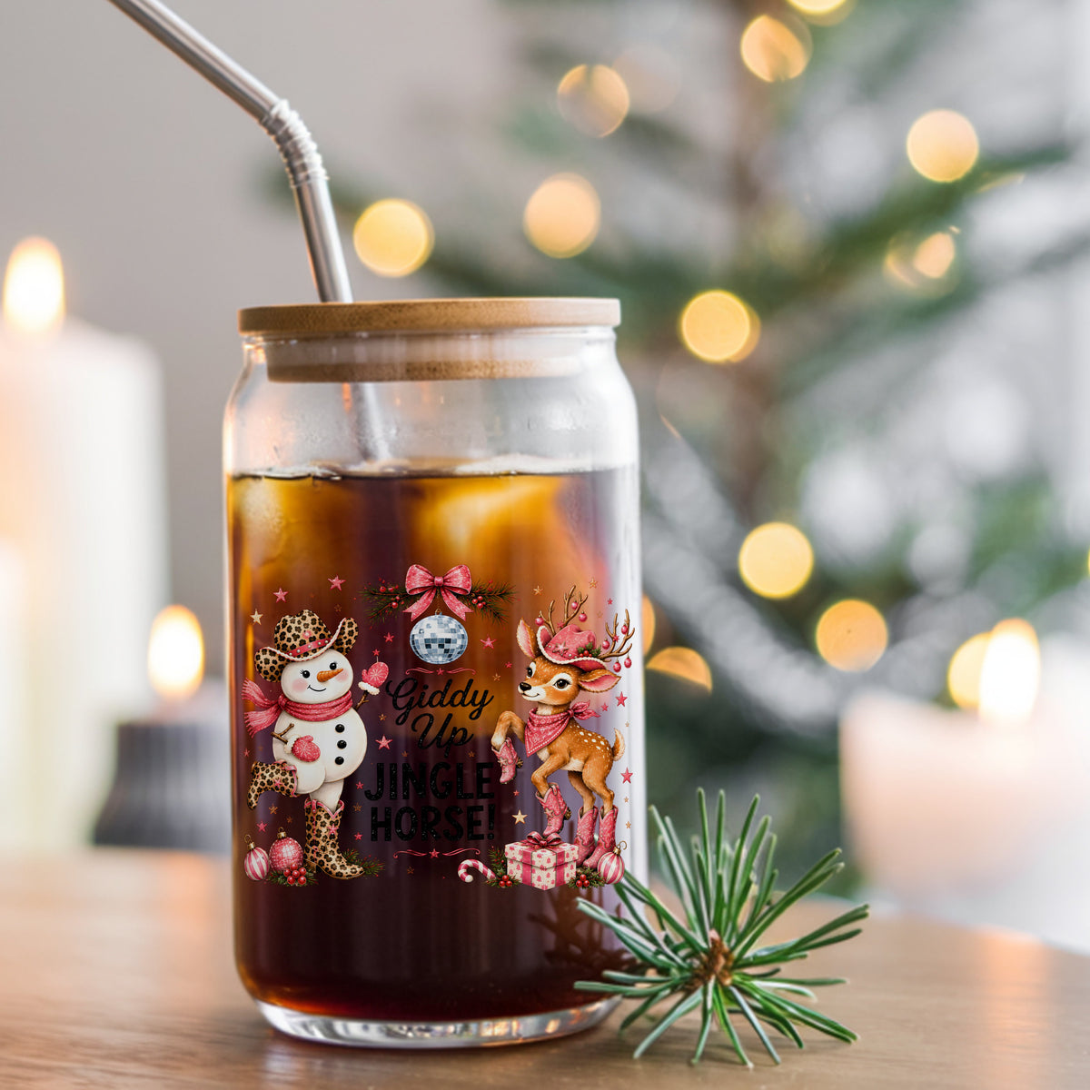 Giddy Up Jingle Horse Snowman Reindeer UV DTF sticker applied to a glass can cup of iced coffee with a straw