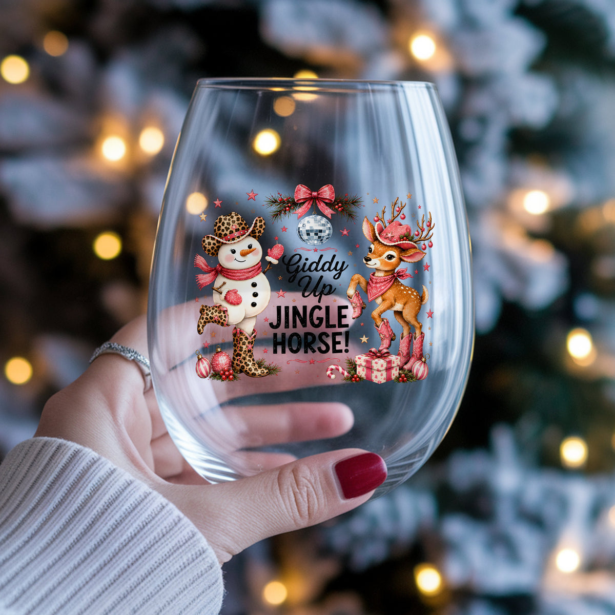 Giddy Up Jingle Horse Snowman Reindeer UV DTF sticker applied to a stemless wine glass held in hand